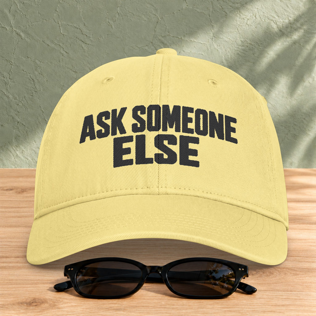 Ask Someone Else washed cap in Butter, front view with slogan lettering