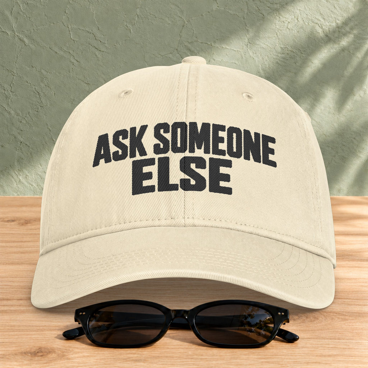 Ask Someone Else washed cap in Ivory, front view with slogan lettering