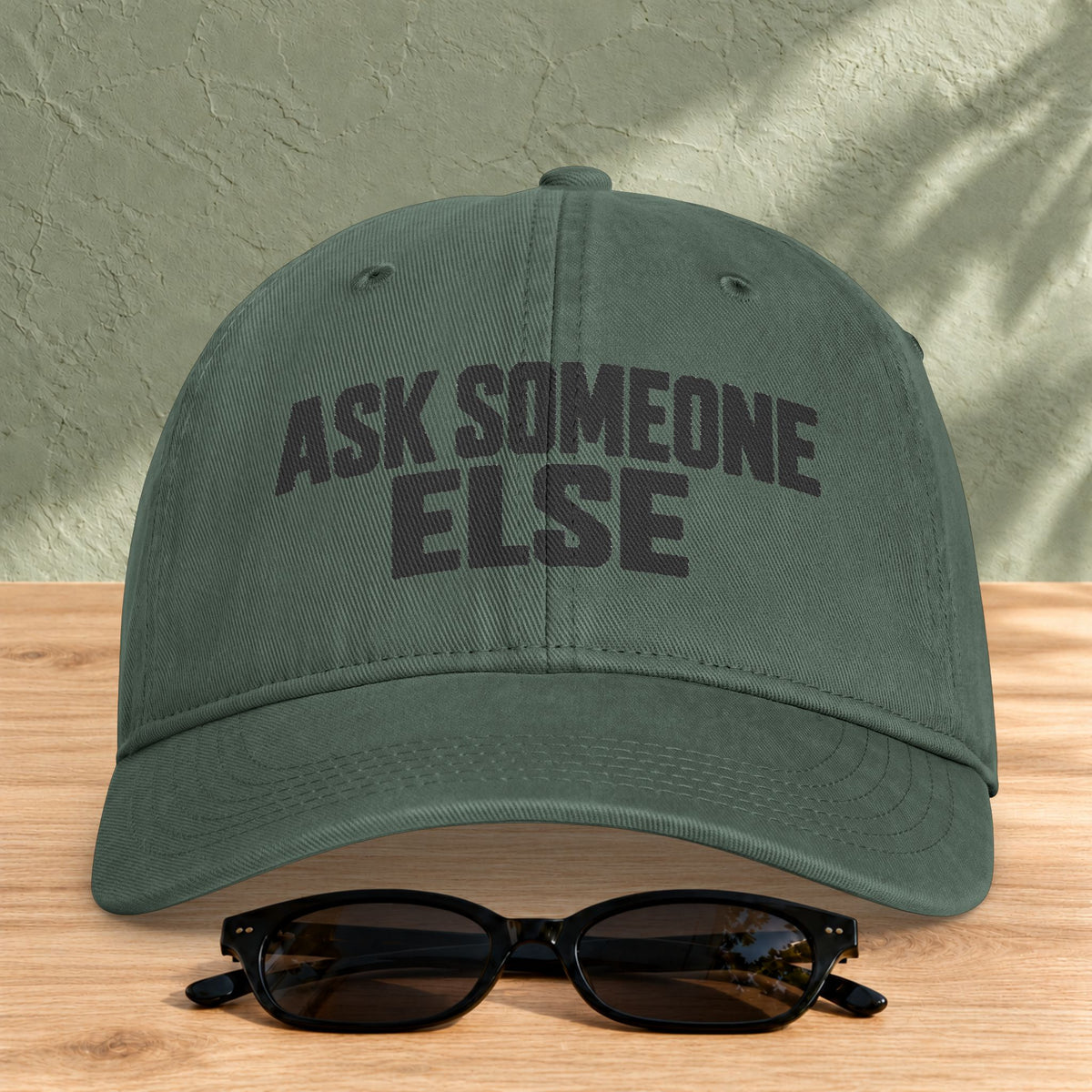 Ask Someone Else washed cap in Moss, front view with slogan lettering